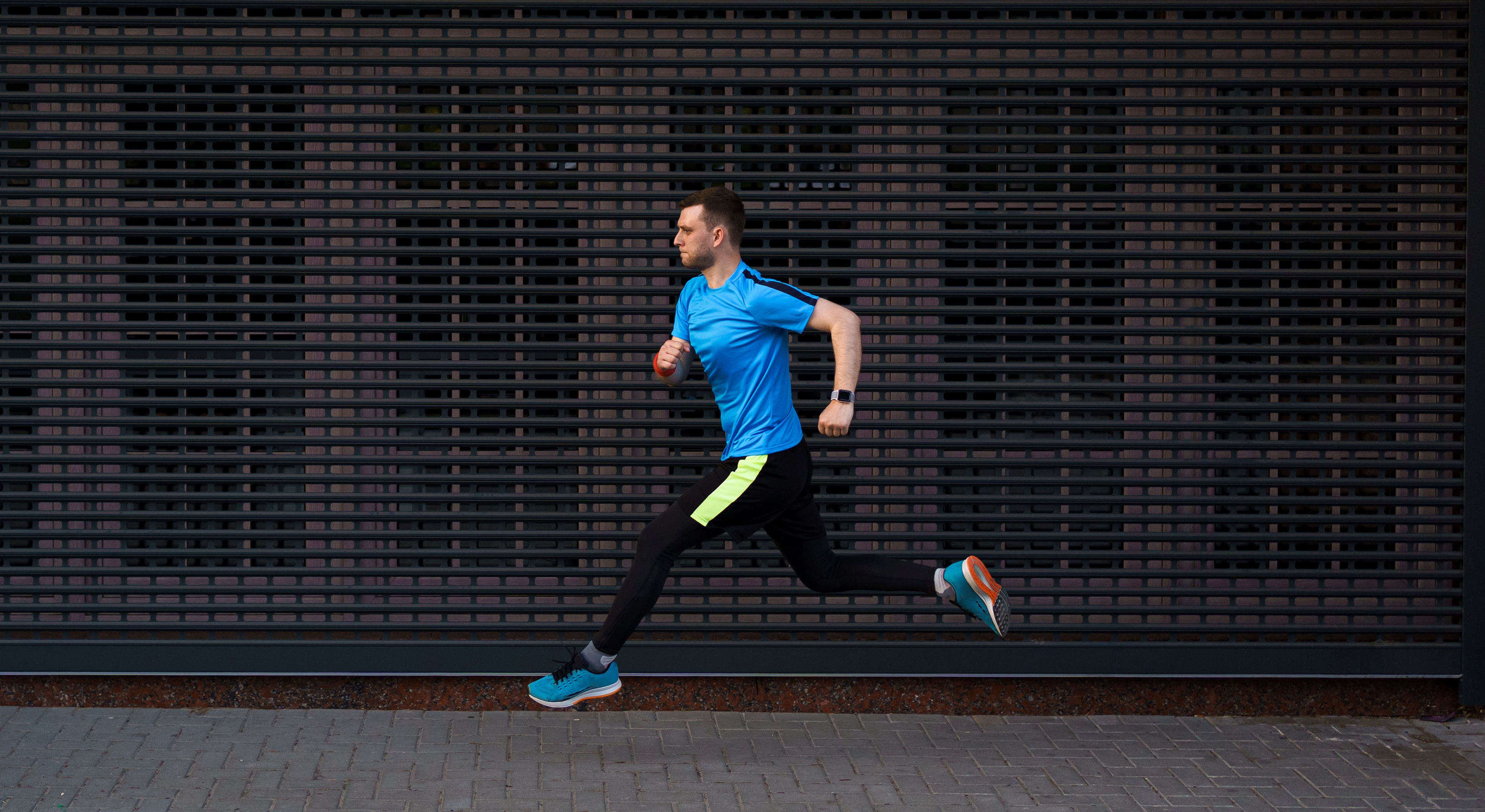 athletic-man-running-at-urban-street